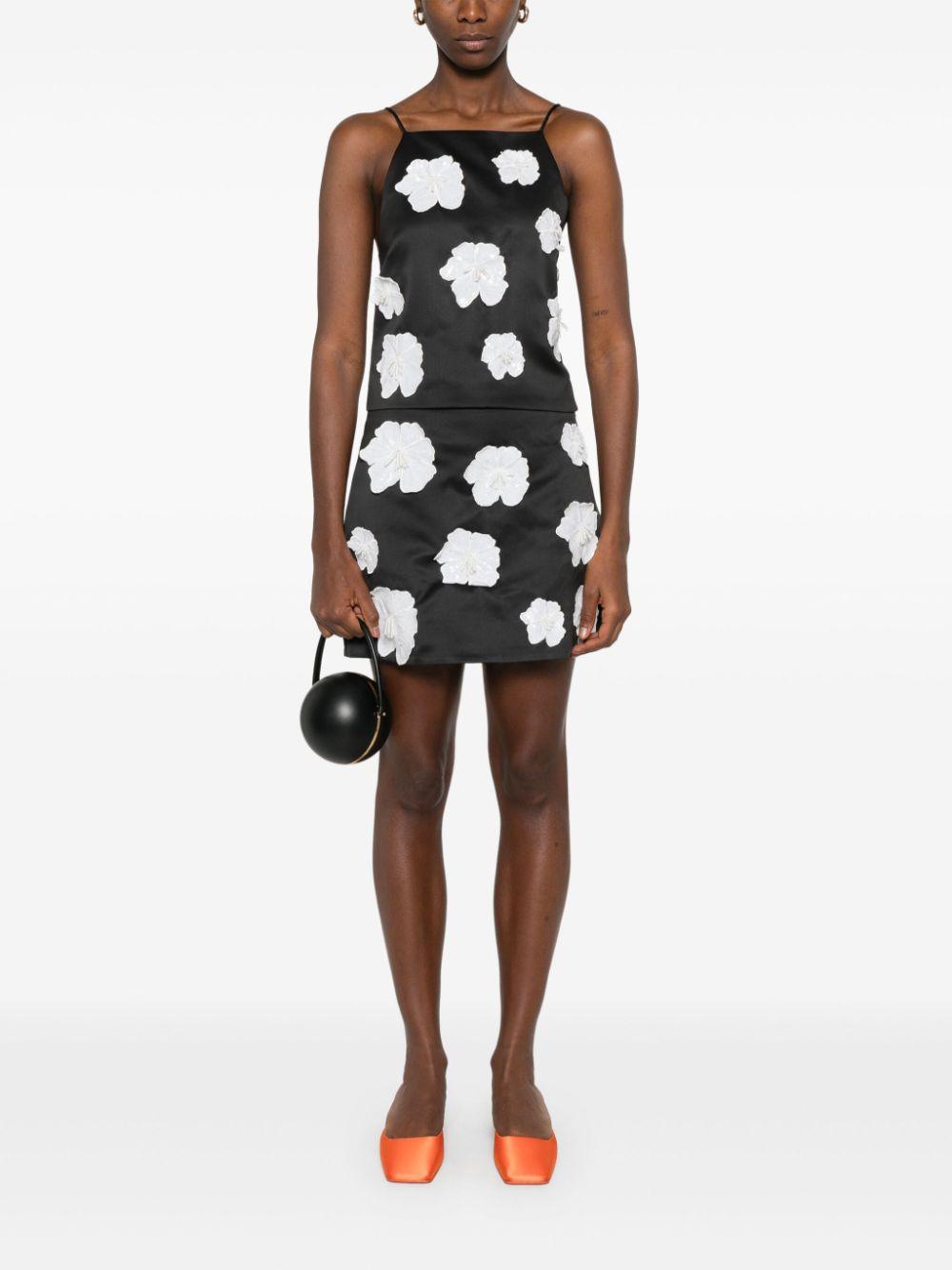 Minigonna in raso con applicazione a fiori 113238100 100 BLACK ROTATE