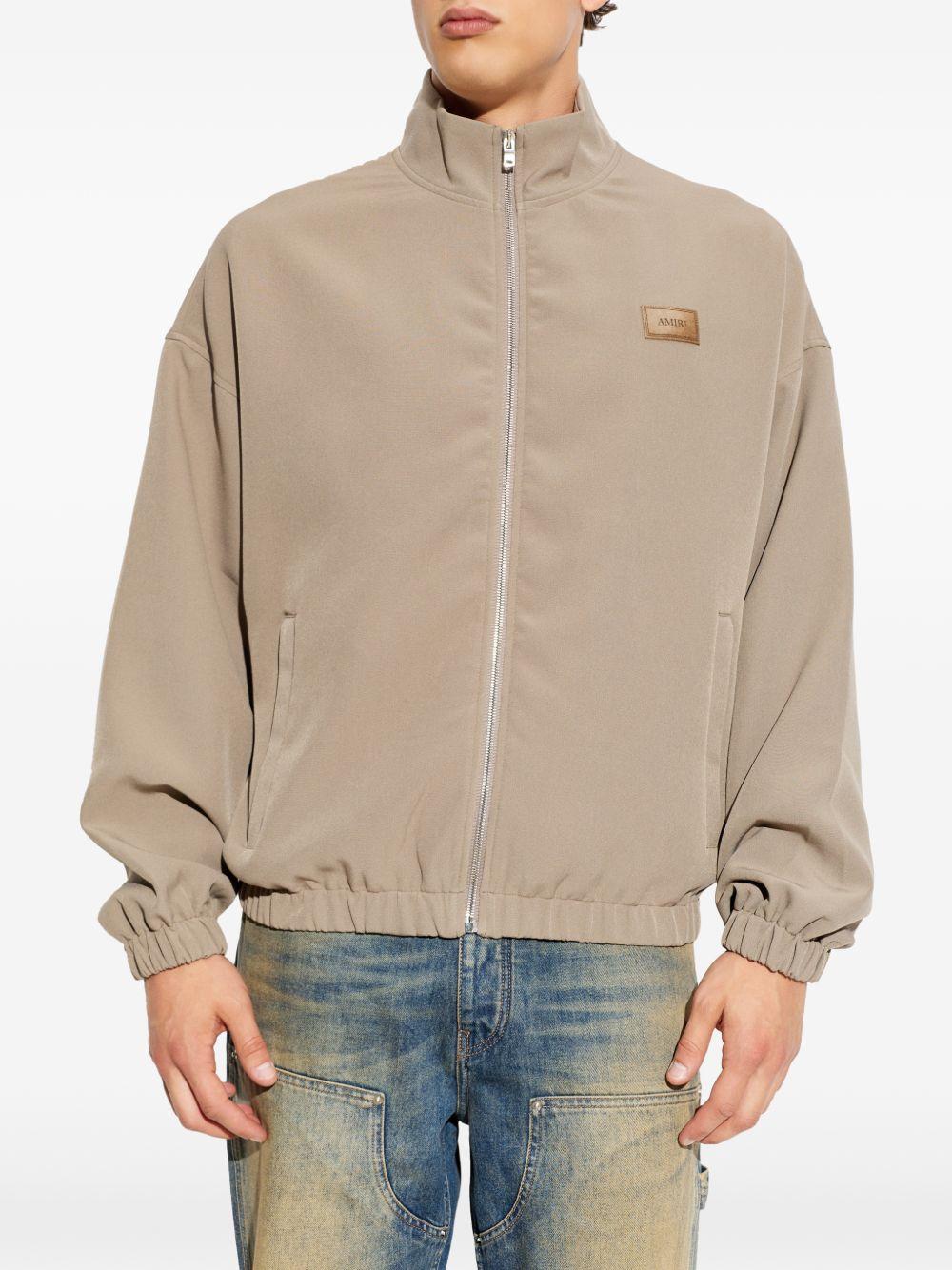 PATCH CADY TRACK JKT AMOUJA1135 DARK SAND AMIRI 